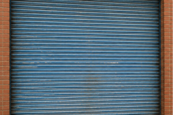 Faded roller shutter door before repainting in Daventry