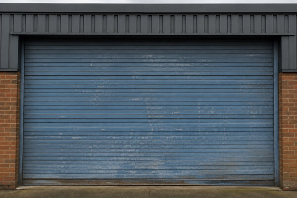 Commercial roller shutter door before repainting in Daventry
