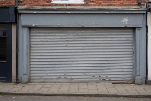 Faded commercial roller shutter before painting and spraying in Milton Keynes