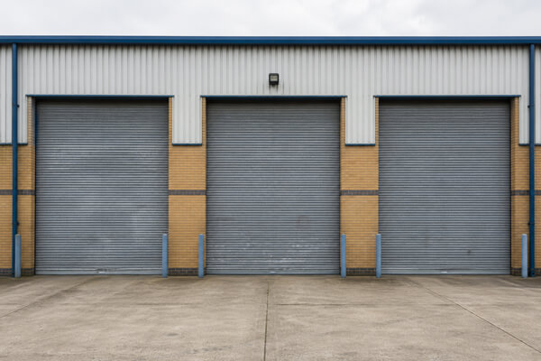Multiple roller shutter doors before painting in Flitwick